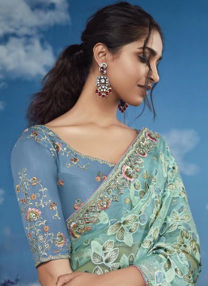Turquoise Brasso Designer Blouse with Attached Tussles On Pallu