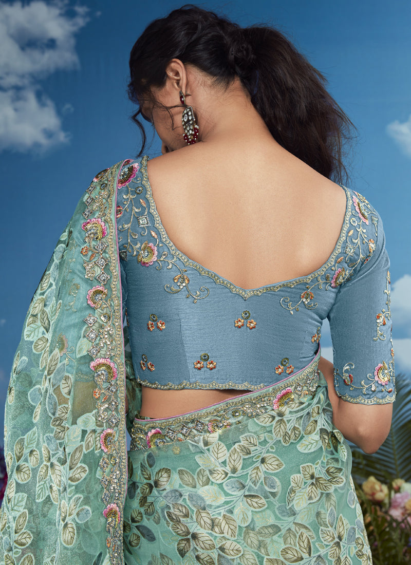 Turquoise Brasso Designer Blouse with Attached Tussles On Pallu