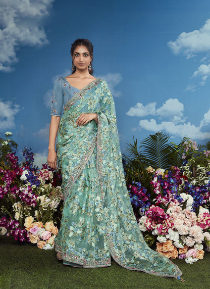 Turquoise Brasso Designer Blouse with Attached Tussles On Pallu